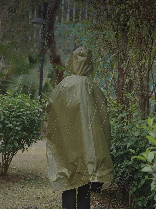 person wearing olive green Ultimate Rainy Day Protector raincoat with hood in rainy outdoor setting